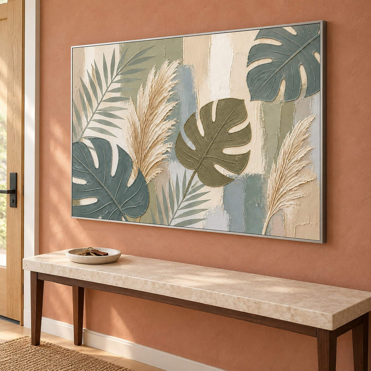 Sage leaves and ivory pampas grasses painting in a silver frame in an entryway.