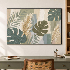 Sage leaves and ivory pampas grasses painting in a black frame in a home office.