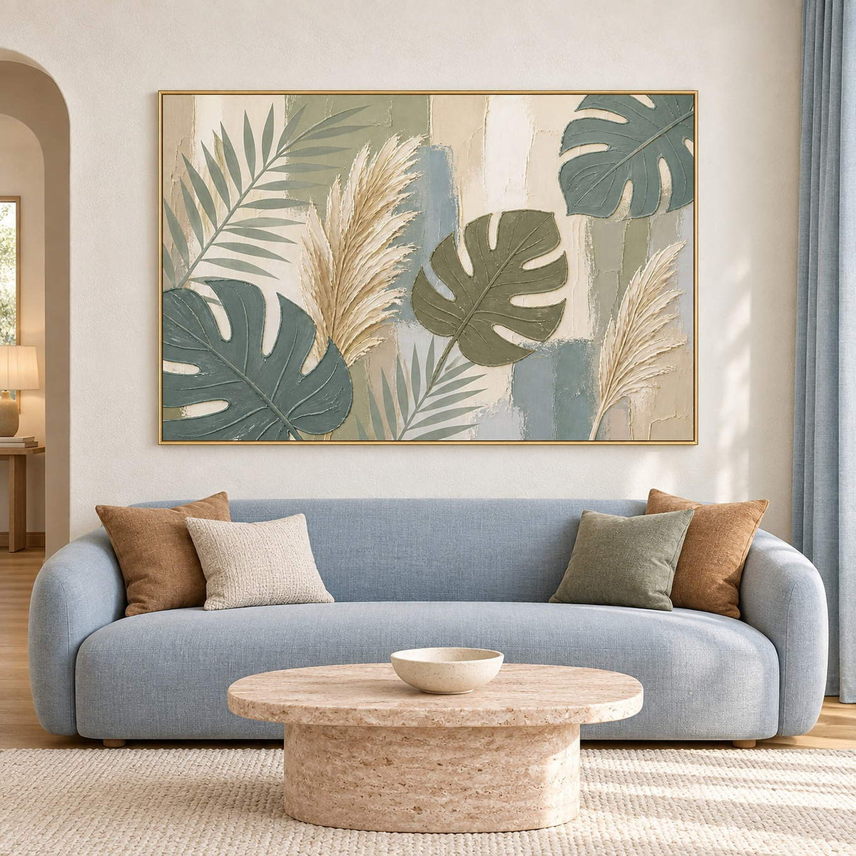Sage leaves and ivory pampas grasses painting in a gold frame in a living room.