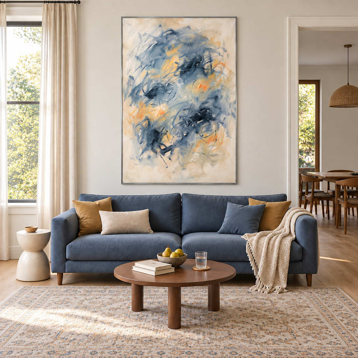 Let Your Thoughts Wander in a silver frame above a blue sofa with mustard cushions and a small round coffee table.