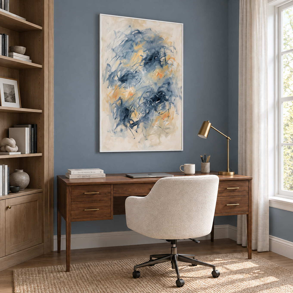 Let Your Thoughts Wander in a white frame above a wood desk and cream office chair against a blue-gray wall.