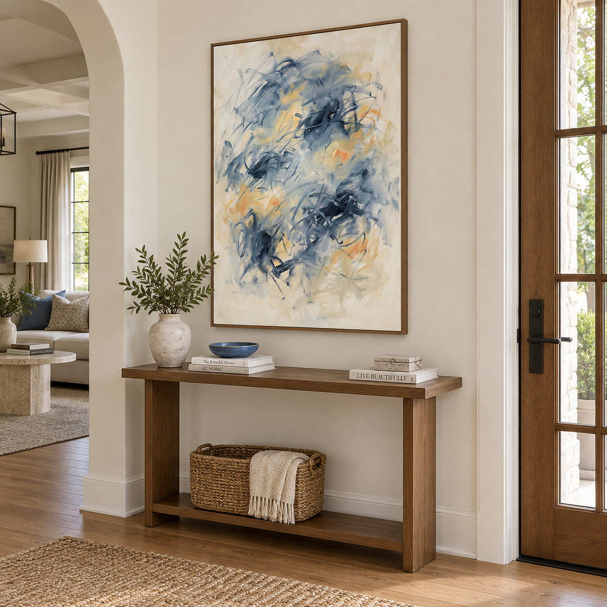 Let Your Thoughts Wander in a wood frame above an entryway console with a ceramic vase and woven basket.