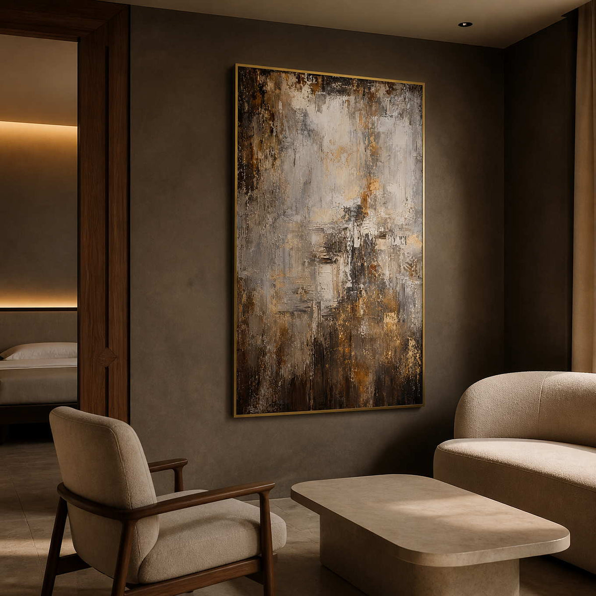 Gold-framed abstract painting adding depth to a boutique hotel suite.