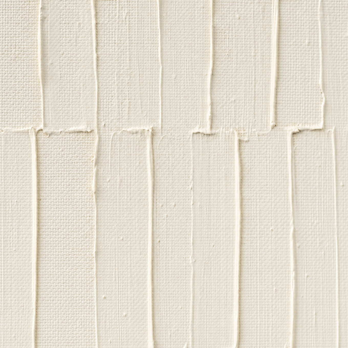 Close-up of raised ivory lines and hand-shaped plaster texture.