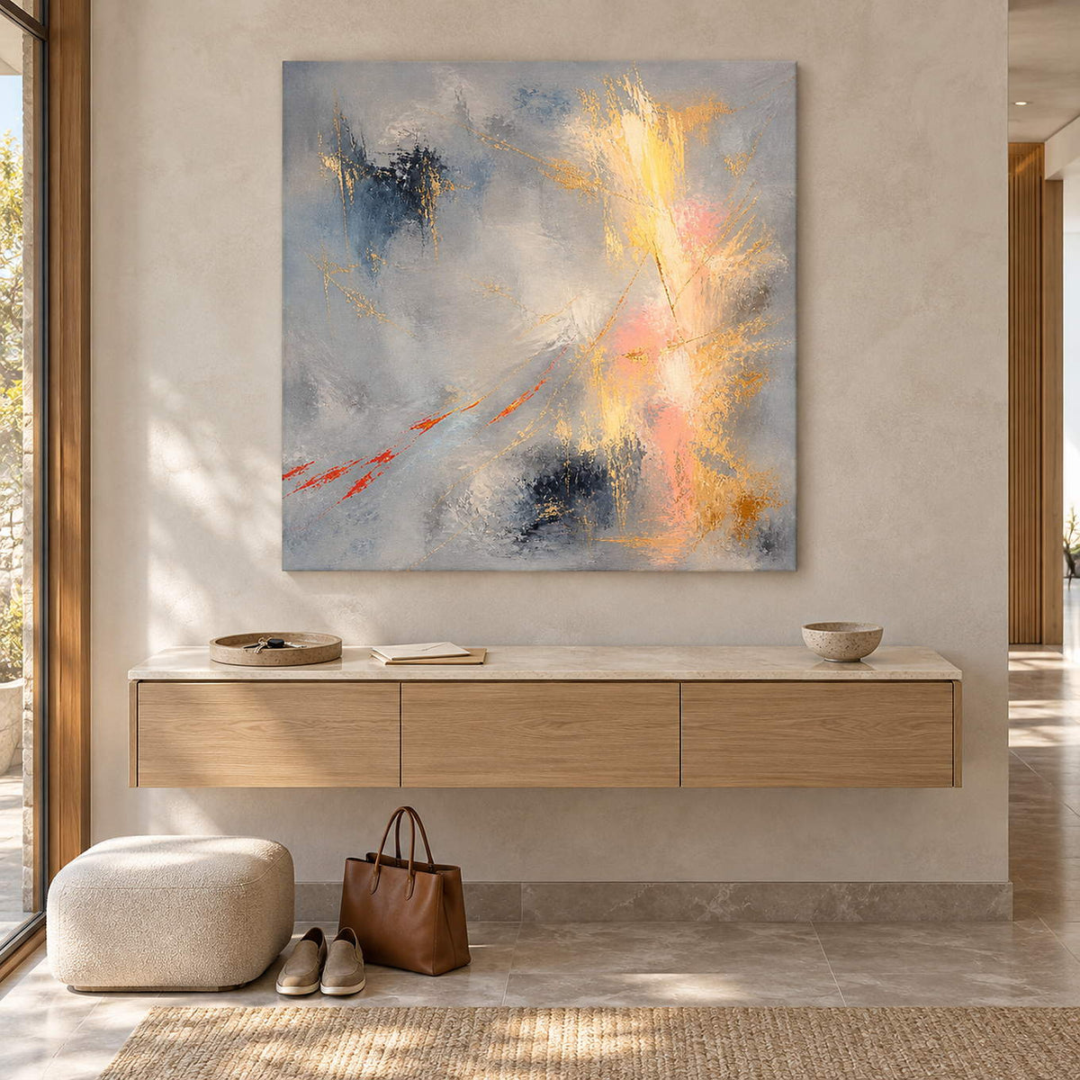 Blue-gray abstract painting with gold, blush, and dark blue marks without an outer frame in an entryway.