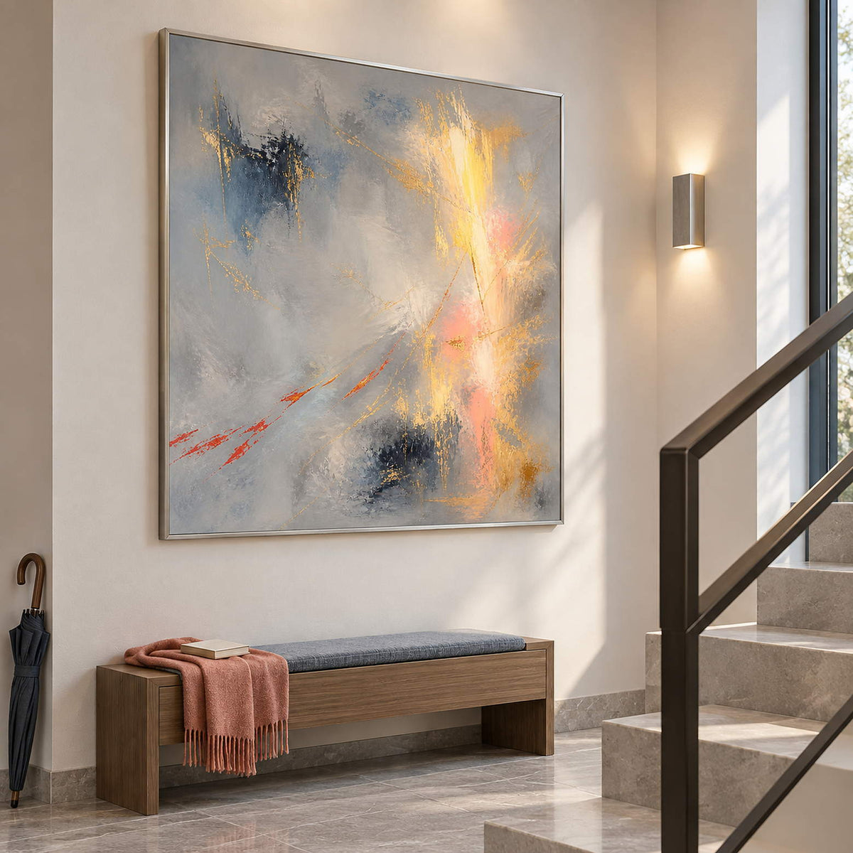 Blue-gray abstract painting with gold, blush, and dark blue marks in a silver frame on a stair landing.