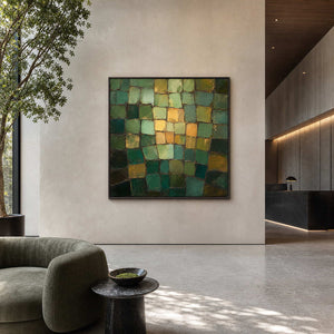 Square green abstract painting displayed in a biophilic hotel lobby.