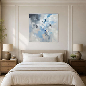 Icy blue and white abstract canvas above a serene ivory bedroom.