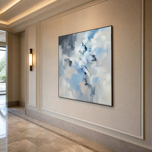 Square blue and white abstract wall art along an elegant hallway.