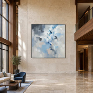 Large blue and white abstract painting displayed in a contemporary hotel lobby.