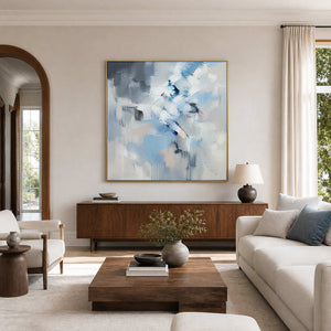 Icy blue, white, and gray square textured abstract wall art in a neutral living room.