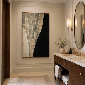 Wood framed woven abstract artwork beside a marble vanity in a bathroom dry area.