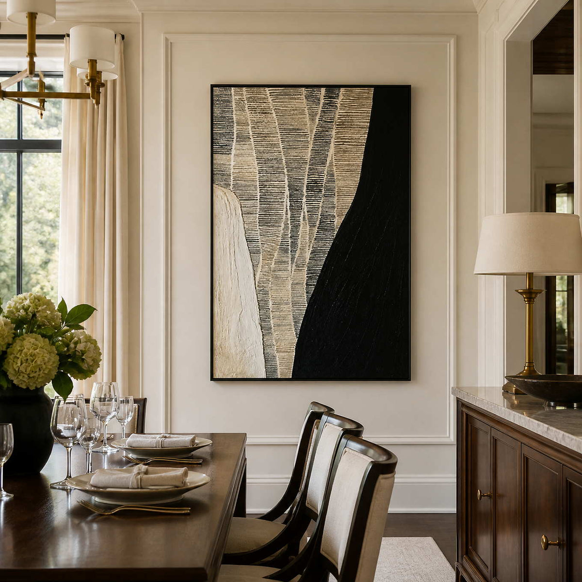 Black framed woven abstract artwork beside a wooden dining table and white chairs.