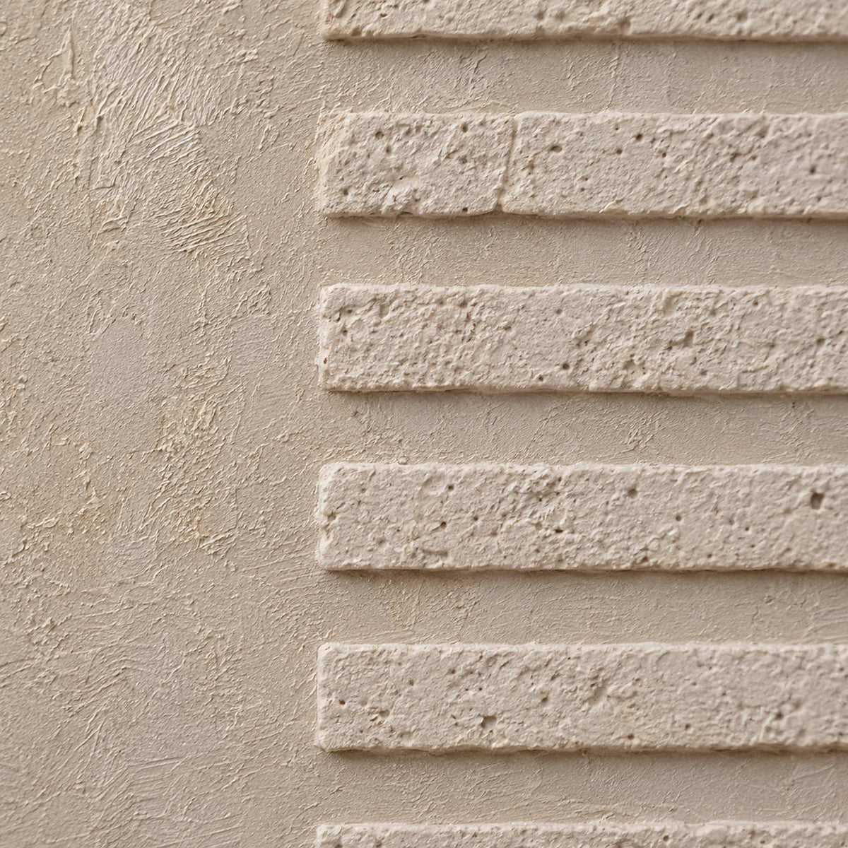 Close-up of raised ivory lines on textured canvas.