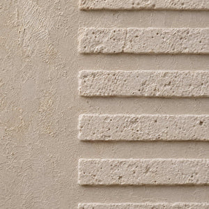Close-up of raised ivory lines on textured canvas.