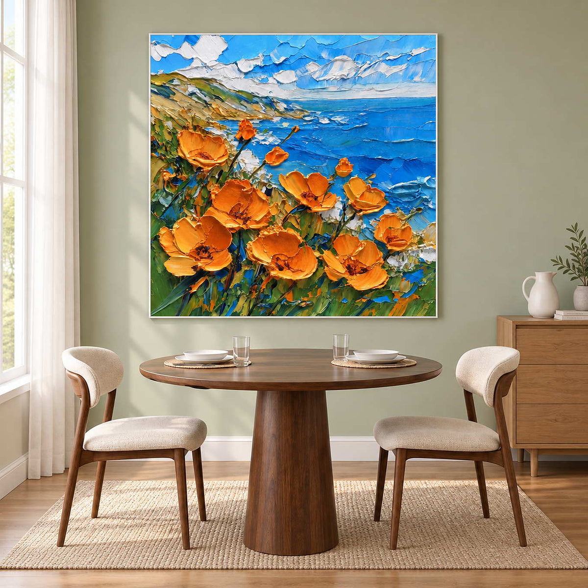 Blue sea and orange flowers behind a round wooden table.