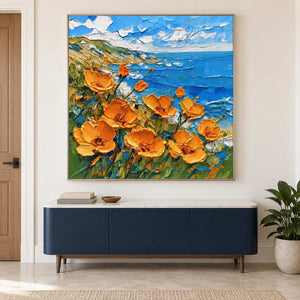 Square flower-and-sea painting above a blue sideboard.