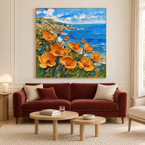 Orange coastal flowers painting above a burgundy sofa.