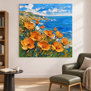 Coastal flowers artwork beside a green chair and footstool.