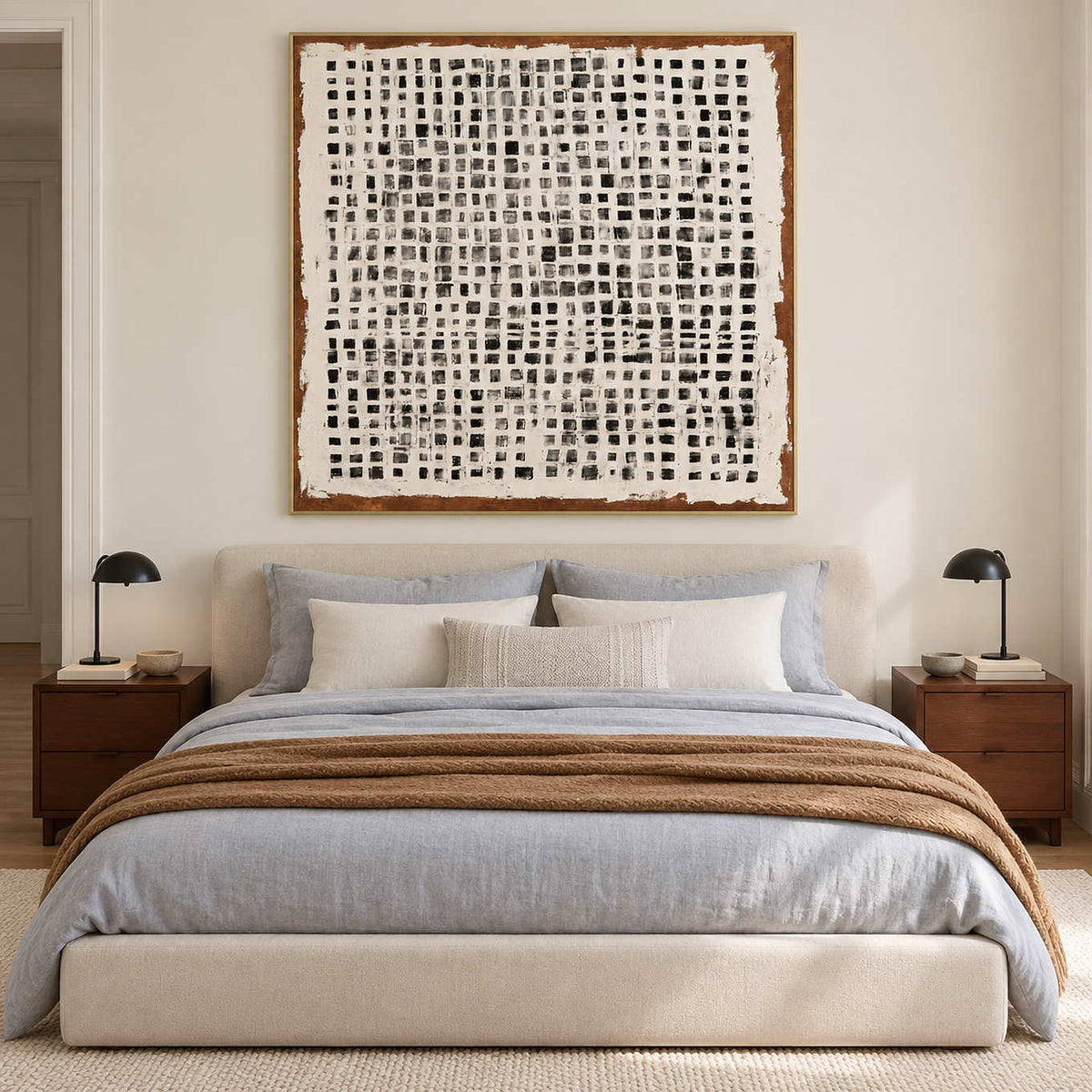 Square geometric artwork above a bed with gray and brown bedding.