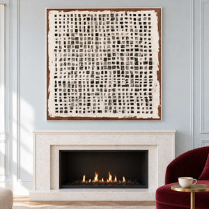 Grid abstract above a fireplace beside a burgundy chair.