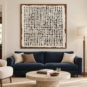 Square grid artwork above a dark blue sofa.