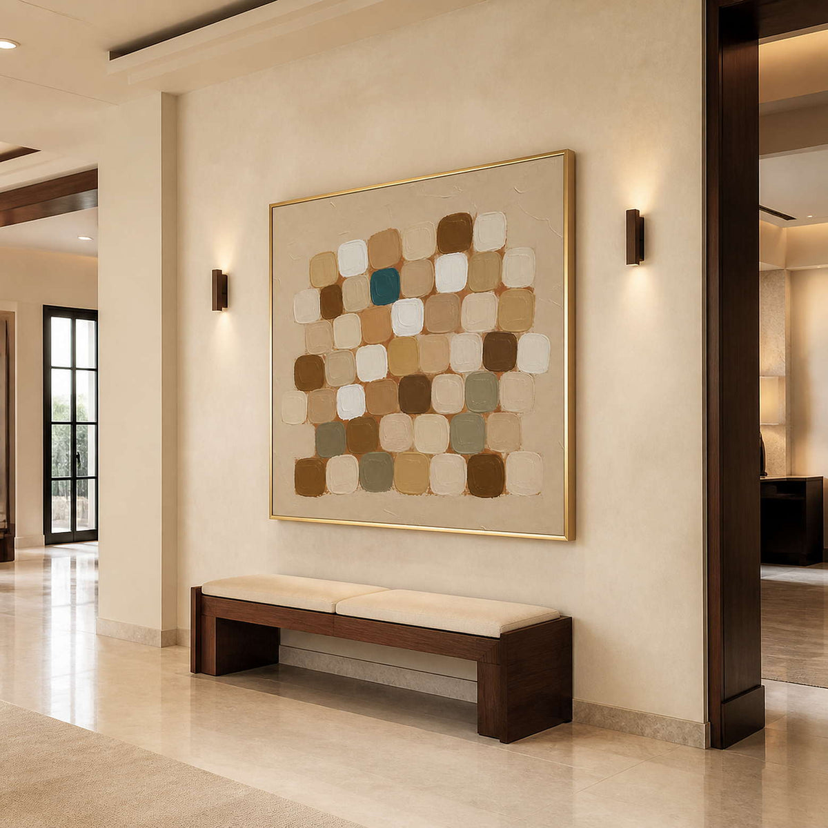 Gold framed abstract squares above a wooden hallway bench between warm wall lights.