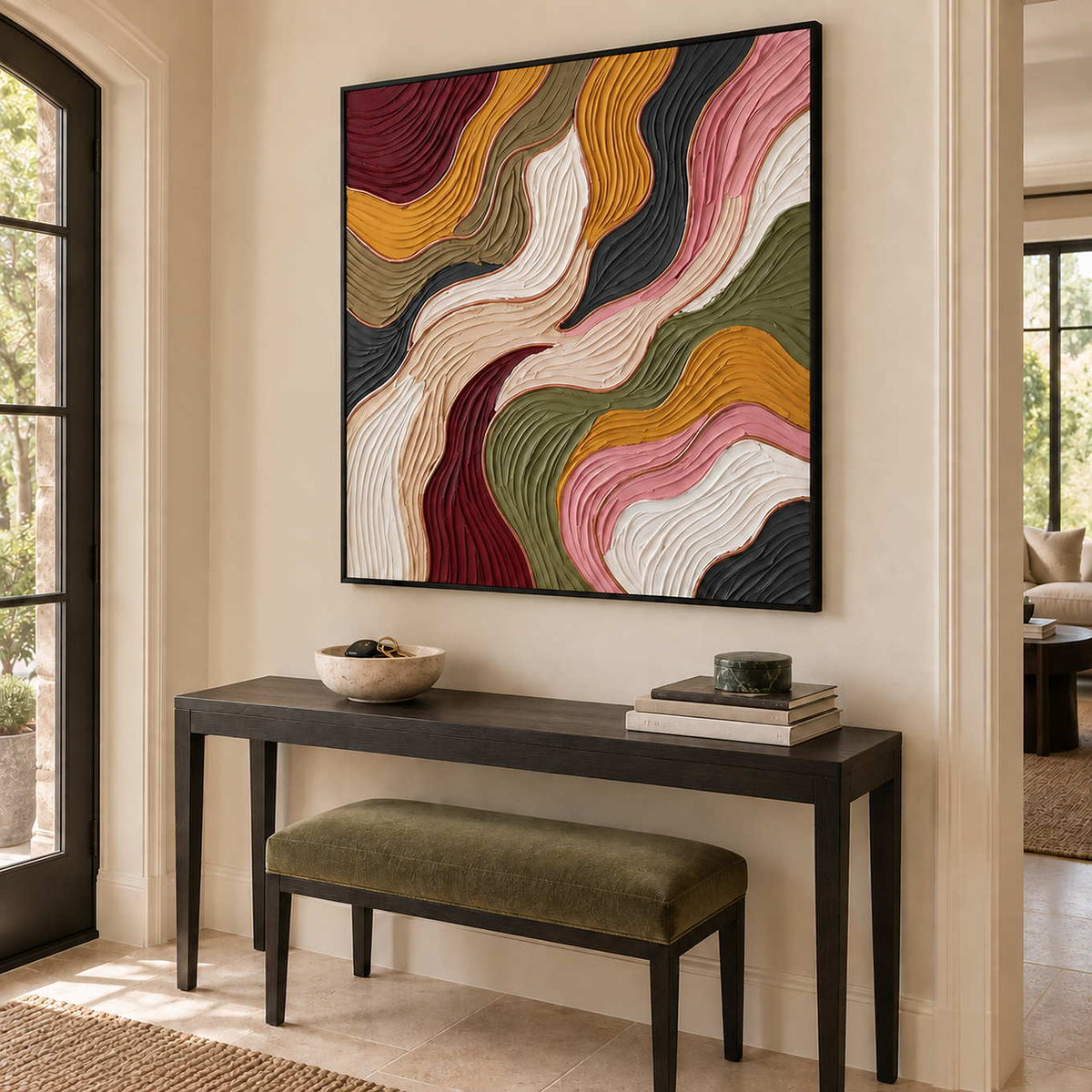 Love in Motion in a black frame above a dark hallway console and an olive upholstered bench.