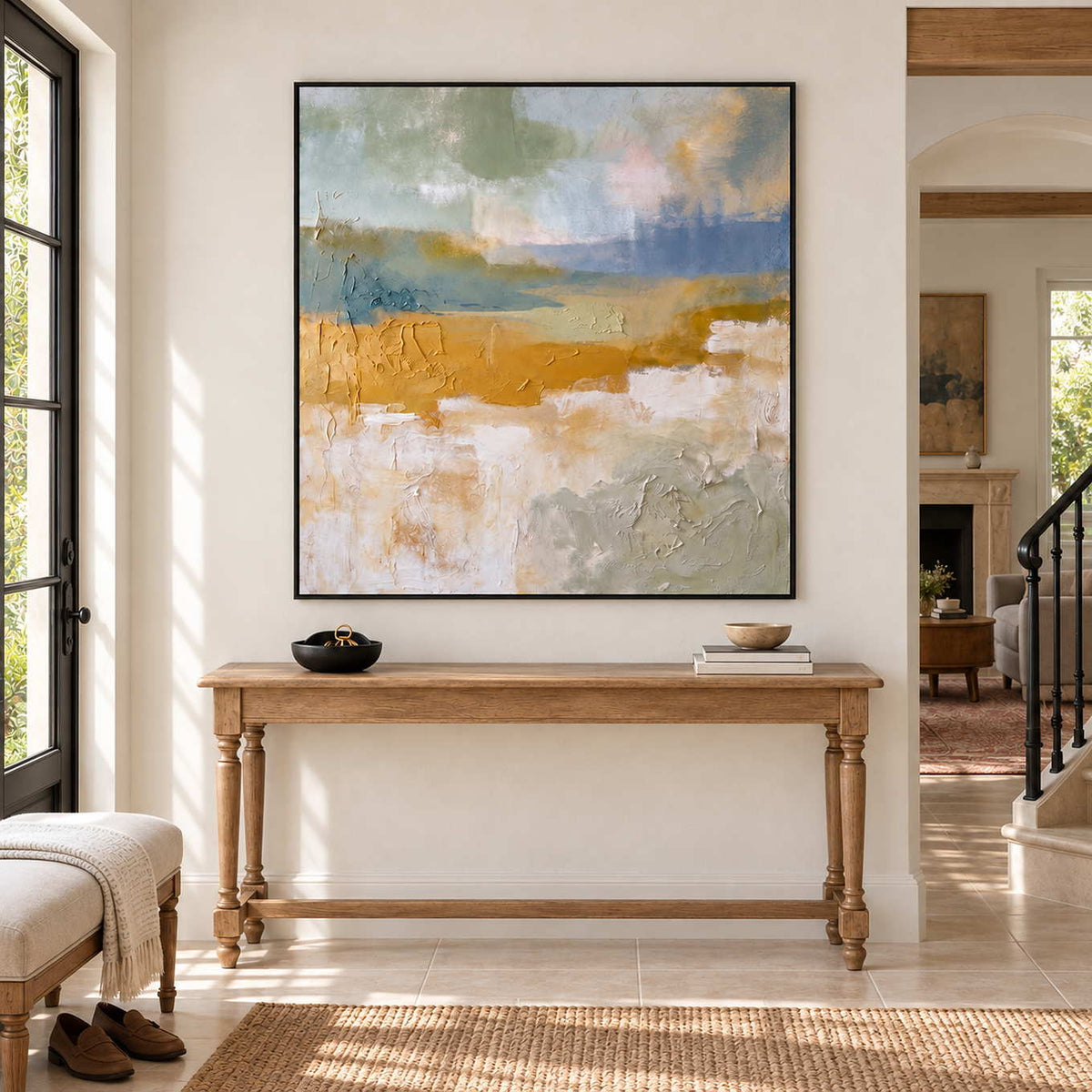 Meeting the Open Country in a black frame above a turned-leg wood hallway console beside an open doorway.