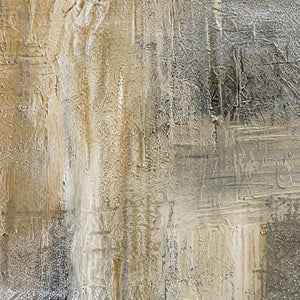 Close view of scraped beige and gray paint layers with fine surface ridges.