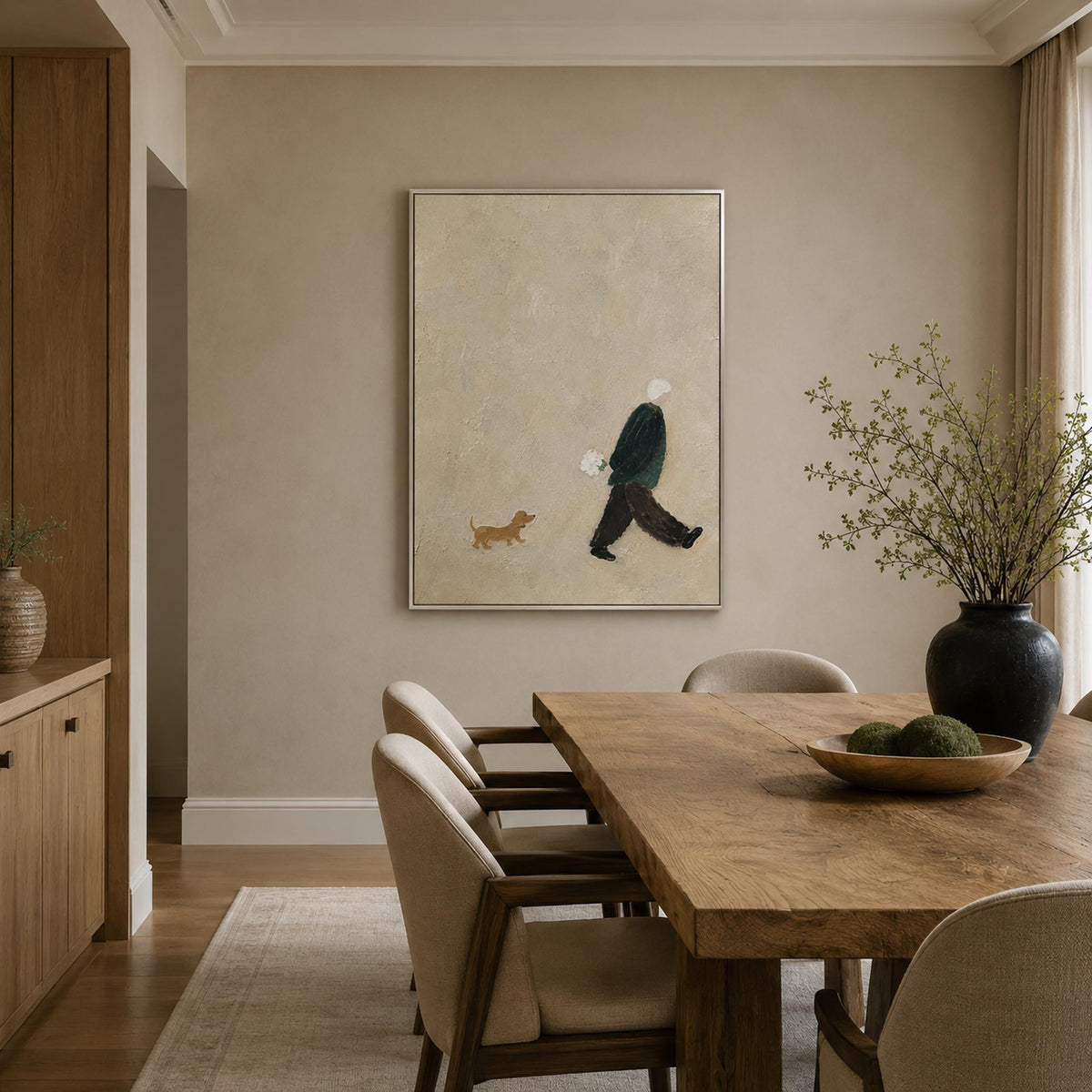 Neutral figure and dog painting in a refined dining room.