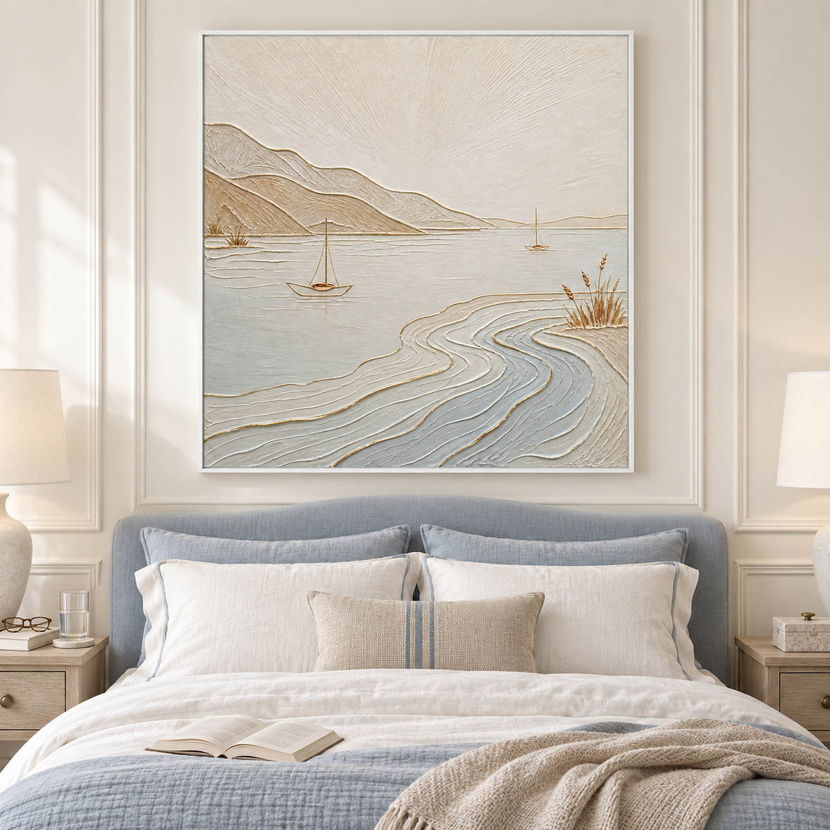 Pale coastal painting with sailboats, sandy hills, and curving wave contours in a white frame in a bedroom.