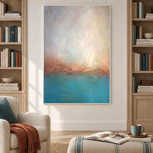 Turquoise coastal painting with a warm shoreline and a luminous pale sky in a white frame in a reading room.