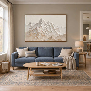 Mountains Keeping Watch in a wood frame above a blue sofa and light wood coffee table.