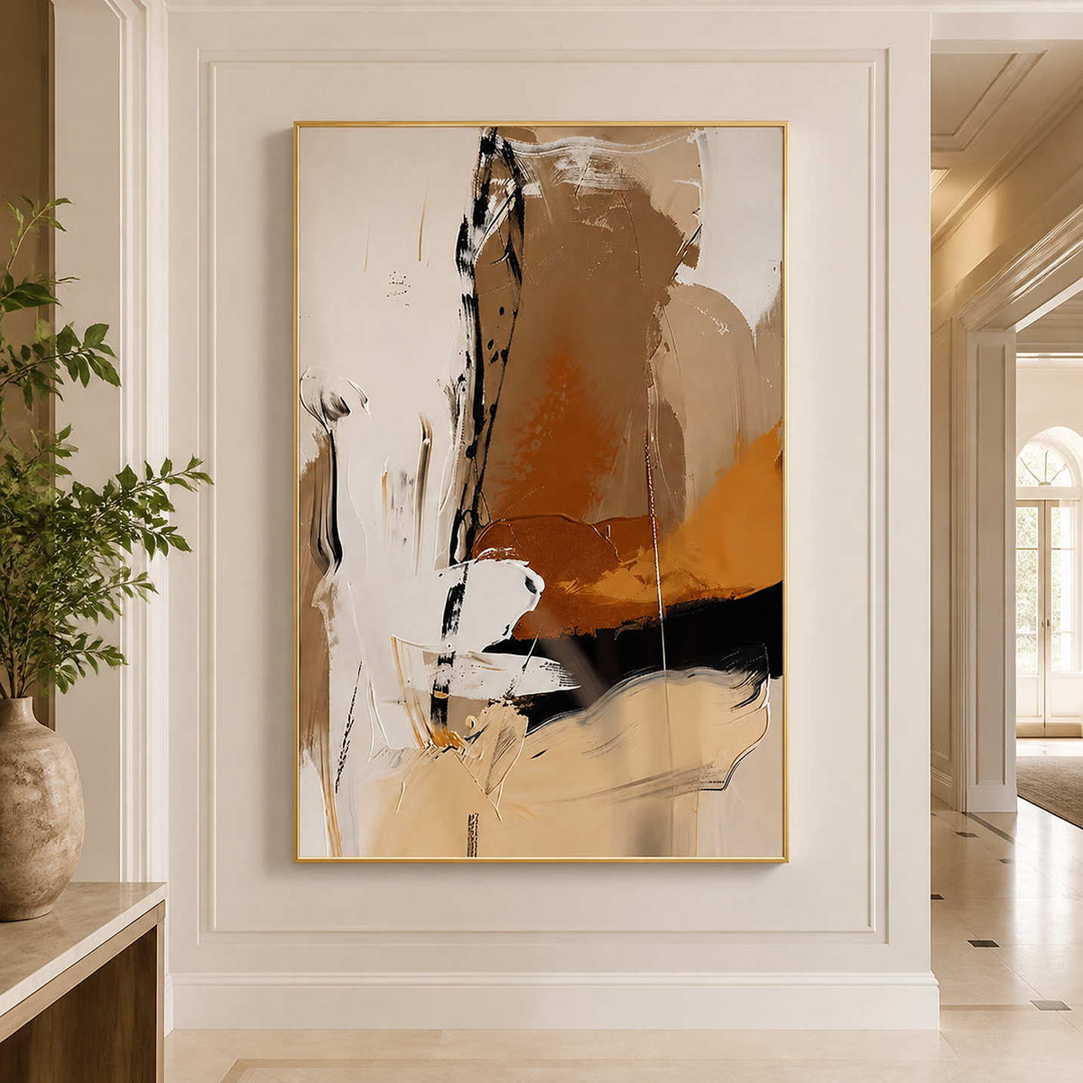 Gold framed ochre and cream abstract artwork on a bright paneled hallway wall.