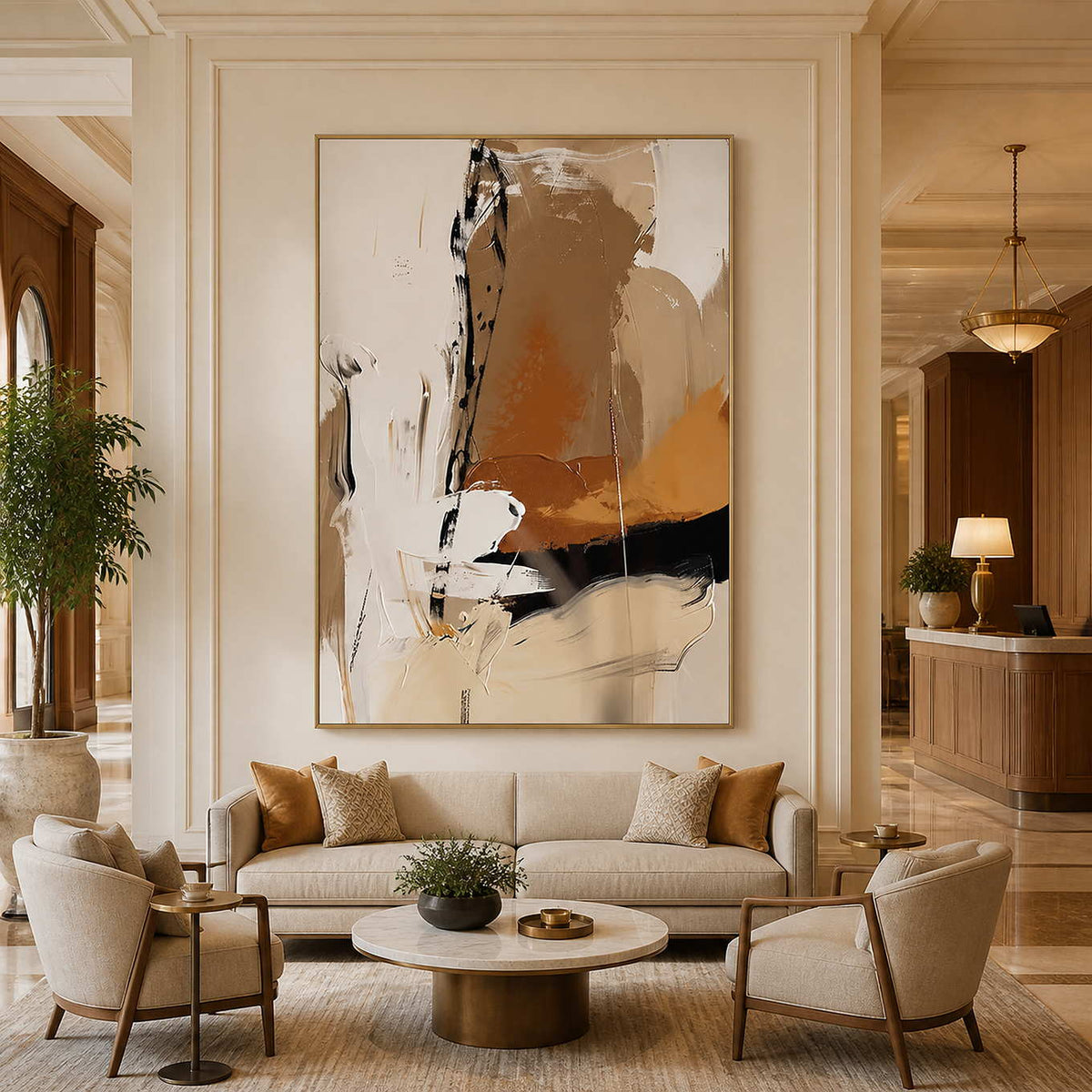Gold framed cream and ochre artwork above lounge seating in a hotel lobby.