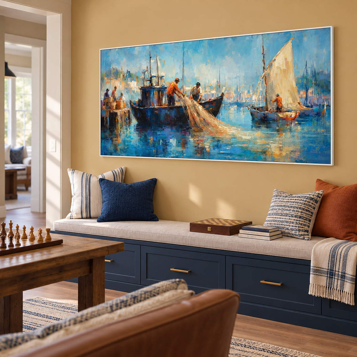 Hand-painted harbor scene with fishermen, sailboats, and luminous blue water, displayed in a family room in a white frame.