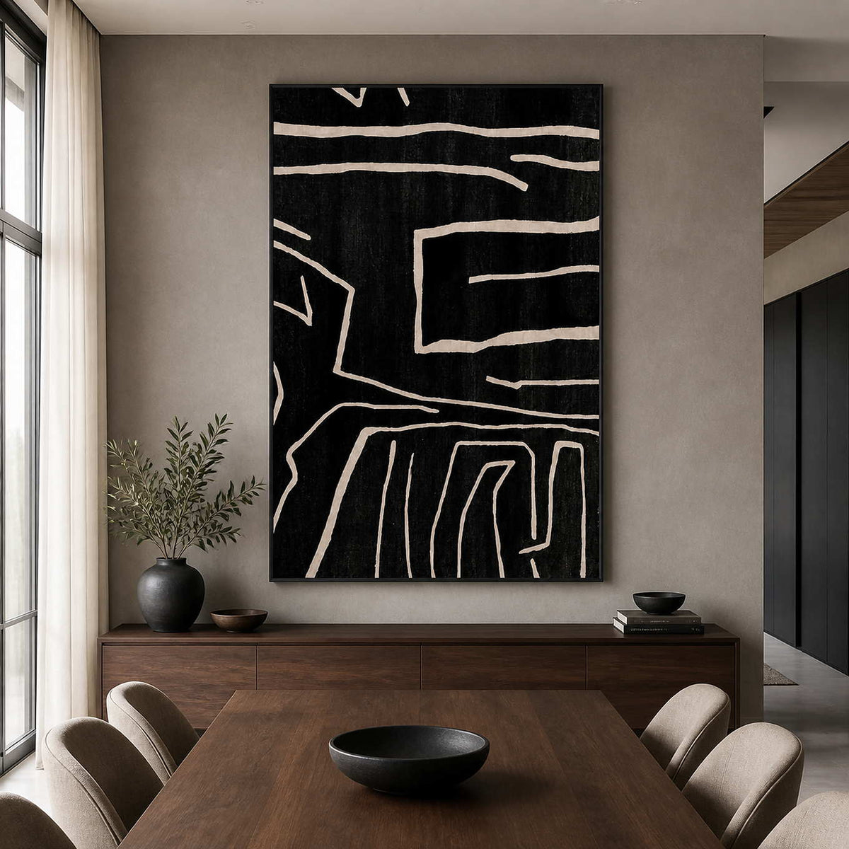Pale lines cross black abstract artwork above a dark wooden dining table.