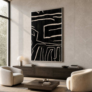 Silver framed black line artwork hangs above walnut cabinetry between cream armchairs.