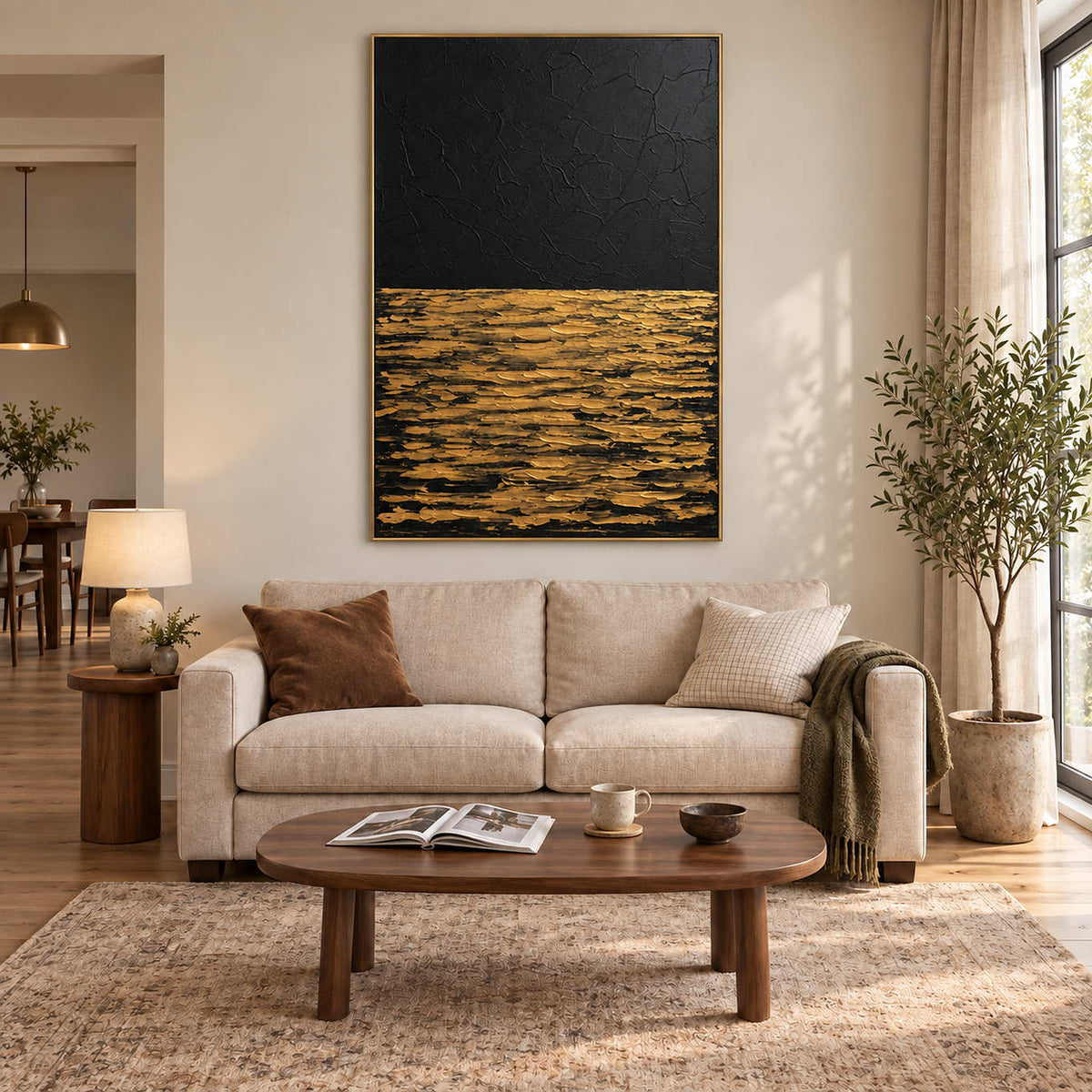 Night's Gentle Glow in a gold frame above a cream sofa, with gold textured strokes beneath a deep black field.