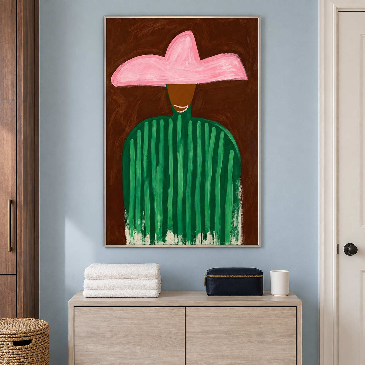 Green-striped figure above a pale cabinet holding folded towels and a dark case.