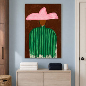 Green-striped figure above a pale cabinet holding folded towels and a dark case.