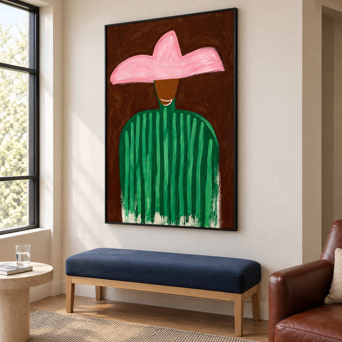 Tall pink-hat portrait above a navy bench beside a bright window.
