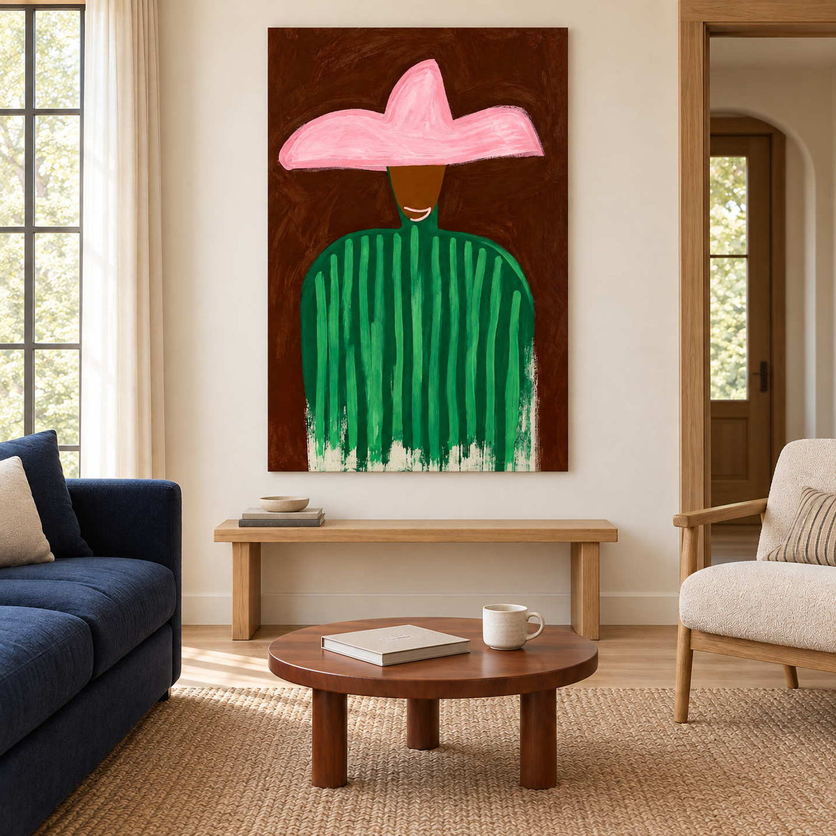 Pink-hat portrait above a wooden bench between a navy sofa and a cream armchair.