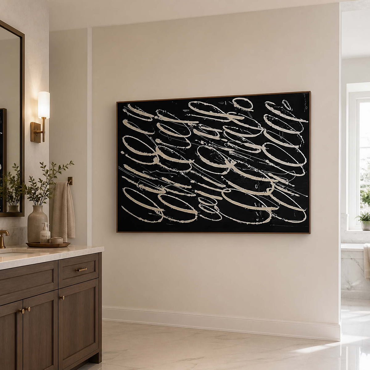 Wood framed black abstract wall art beside a neutral bathroom vanity.