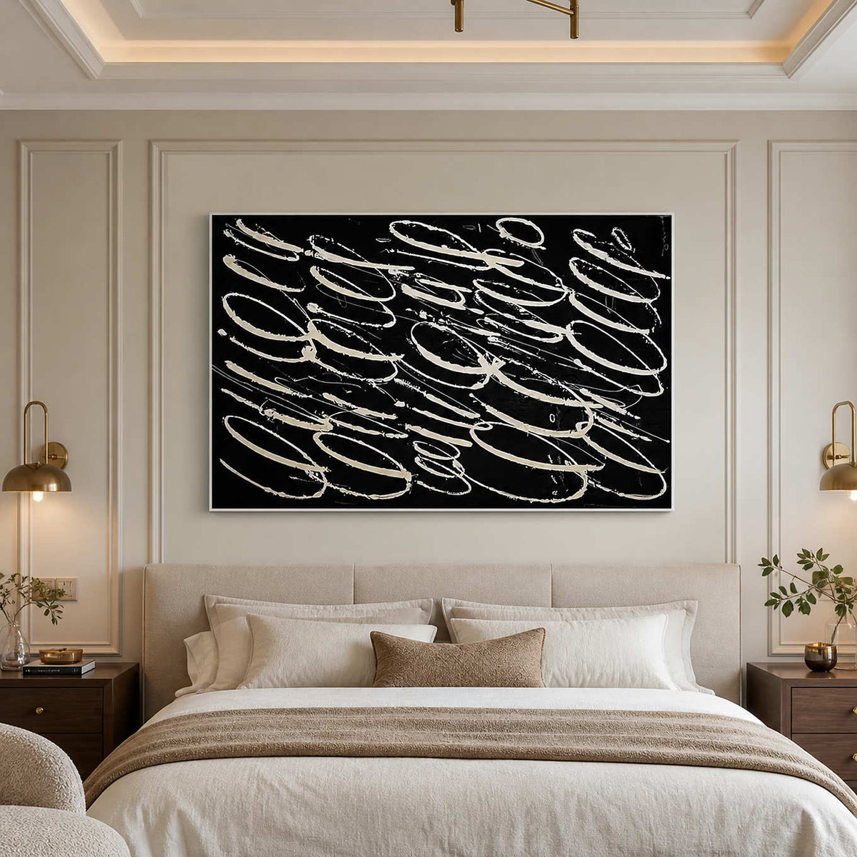 White framed black abstract painting above a cream upholstered bed.