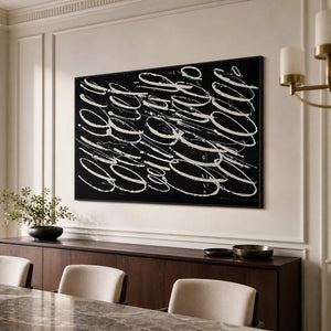 Black framed pale loop artwork above a dining sideboard beside a stone table.
