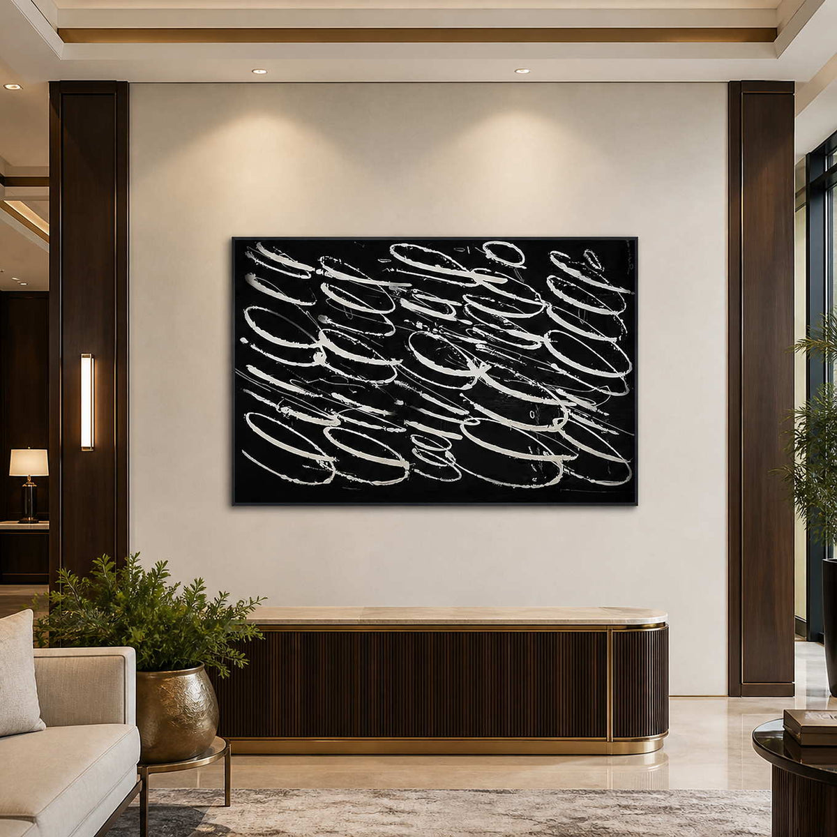 Black framed pale looping artwork above a ribbed console in a hotel lobby.