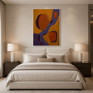 Ochre and violet artwork creating warmth above a neutral bedroom.