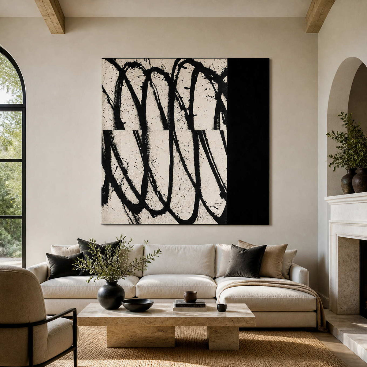 Frameless black and white looping abstract artwork above a cream sofa beside a stone fireplace.